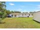 Spacious backyard featuring a well-maintained lawn and the exterior of the home with neutral paint at 214 S Cottage Hill Rd, Orlando, FL 32805