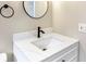 Bright bathroom showcasing white vanity with bronze faucet and round mirror at 214 S Cottage Hill Rd, Orlando, FL 32805