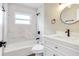 Updated bathroom featuring marble-look tile, tub, and modern vanity at 214 S Cottage Hill Rd, Orlando, FL 32805