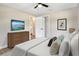 Inviting bedroom with ceiling fan, decorative pillows, vinyl floors, and TV at 214 S Cottage Hill Rd, Orlando, FL 32805