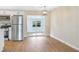 Dining area with modern light fixture with stainless steel refrigerator and sliding door leading to backyard at 214 S Cottage Hill Rd, Orlando, FL 32805