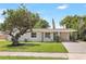 Charming single-story home featuring a well-maintained lawn and mature shade tree at 214 S Cottage Hill Rd, Orlando, FL 32805