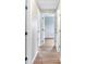 Hallway with wood floors and multiple doors to rooms at 214 S Cottage Hill Rd, Orlando, FL 32805