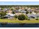 Residential neighborhood with pond featuring well-manicured lawns, mature trees, and swimming pools at 2512 Chapala Dr, Kissimmee, FL 34746