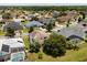 Neighborhood aerial view showcasing well-kept homes, mature trees, and lush green lawns at 2512 Chapala Dr, Kissimmee, FL 34746