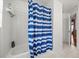 Bathroom featuring white tiled shower with blue and white shower curtain at 2512 Chapala Dr, Kissimmee, FL 34746