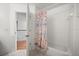 Bright bathroom with shower and tub featuring tiled floors and walls at 2512 Chapala Dr, Kissimmee, FL 34746