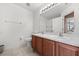 Bathroom featuring tile floors, wood vanity, dual sinks, and a toilet at 2512 Chapala Dr, Kissimmee, FL 34746