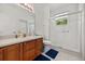 Bright bathroom featuring a glass door shower, white tiling, and a wood vanity at 2512 Chapala Dr, Kissimmee, FL 34746