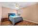 Bedroom featuring a ceiling fan with lights, wood-look floors, and bed at 2512 Chapala Dr, Kissimmee, FL 34746
