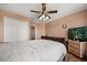 Bedroom with ceiling fan, wood floors, and closet space in a warm tone at 2512 Chapala Dr, Kissimmee, FL 34746