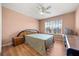 Bedroom featuring a bed, wood-look floors, large window, and ceiling fan at 2512 Chapala Dr, Kissimmee, FL 34746