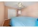 Bedroom featuring a ceiling fan with lights, wood-look floors, and bed at 2512 Chapala Dr, Kissimmee, FL 34746