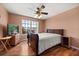Bedroom with hardwood floors, ceiling fan, and a large window for natural light at 2512 Chapala Dr, Kissimmee, FL 34746