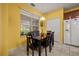 Bright dining room featuring tile floors, a modern chandelier, and large windows offering plenty of natural light at 2512 Chapala Dr, Kissimmee, FL 34746