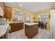 Open kitchen design with tiled flooring, wooden cabinets, and a center island at 2512 Chapala Dr, Kissimmee, FL 34746