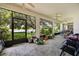 Screened in lanai with tile flooring, several windows, and view of the outdoors at 2512 Chapala Dr, Kissimmee, FL 34746