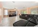 Spacious living room featuring tile floors, natural light, and a large sectional couch with cozy throw pillows at 2512 Chapala Dr, Kissimmee, FL 34746