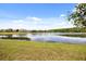 Beautiful pond reflecting the blue sky, surrounded by well-maintained lawns and homes at 2512 Chapala Dr, Kissimmee, FL 34746
