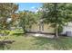 Expansive backyard featuring mature trees, an outbuilding, and a concrete patio at 28 N Osceola Ave, Center Hill, FL 33514