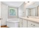 Luxurious bathroom with soaking tub, block window and large vanity at 28 N Osceola Ave, Center Hill, FL 33514