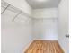 Spacious walk-in closet with metal racking and hardwood flooring at 28 N Osceola Ave, Center Hill, FL 33514