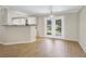 Bright dining area with white cabinets, and glass paneled doors offering a view of the outdoors at 28 N Osceola Ave, Center Hill, FL 33514
