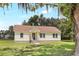 Charming single-story home with a neatly manicured lawn and cozy front porch at 28 N Osceola Ave, Center Hill, FL 33514