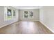 Open living room area with large windows bringing in lots of natural light at 28 N Osceola Ave, Center Hill, FL 33514