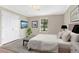 Serene bedroom features a large window, neutral walls, and carpet flooring at 28 N Osceola Ave, Center Hill, FL 33514