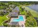 Overhead community pool featuring lounge chairs, manicured landscaping, and a scenic lake view at 305 West Lake Faith Dr # 139, Maitland, FL 32751