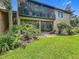 Exterior view showcasing a screened patio and landscaped yard at 305 West Lake Faith Dr # 139, Maitland, FL 32751