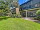 Exterior view showcasing a screened patio with a view of the landscape at 305 West Lake Faith Dr # 139, Maitland, FL 32751