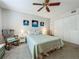 Comfortable bedroom with a queen-size bed, ceiling fan, closet and bright natural light at 305 West Lake Faith Dr # 139, Maitland, FL 32751