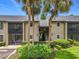 Inviting condo exterior featuring tropical landscaping and easy access to units, offering a serene atmosphere at 305 West Lake Faith Dr # 139, Maitland, FL 32751