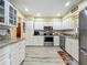 Well-lit kitchen featuring modern white cabinets, stainless steel appliances, and granite countertops, perfect for cooking at 305 West Lake Faith Dr # 139, Maitland, FL 32751