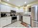 Bright kitchen with white cabinetry, stainless appliances, and granite countertops at 305 West Lake Faith Dr # 139, Maitland, FL 32751