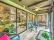 A screened patio featuring comfortable seating, a ceiling fan, and beautiful views at 305 West Lake Faith Dr # 139, Maitland, FL 32751