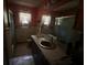 Bathroom featuring a window, toilet, mirror and sink with a shower to the left at 3540 Garland St, Mulberry, FL 33860