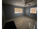 Neutral bedroom featuring gray walls, tile flooring, and natural lighting at 3540 Garland St, Mulberry, FL 33860