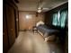 Bedroom featuring wood paneling, tile floors, a ceiling fan, and natural lighting at 3540 Garland St, Mulberry, FL 33860