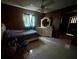Bedroom with paneled walls, tile floor, and a vanity with a decorative mirror at 3540 Garland St, Mulberry, FL 33860