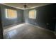 Empty bedroom featuring tile flooring, two windows, and a ceiling fan at 3540 Garland St, Mulberry, FL 33860