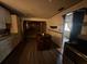 Kitchen featuring wood cabinets, an island, and view to a room beyond at 3540 Garland St, Mulberry, FL 33860