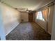 Cozy living room with carpet, a front door, and a window with curtains at 3540 Garland St, Mulberry, FL 33860