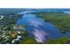 Scenic aerial view of waterfront property surrounded by lush trees and sparkling river waters at 418 Acacia Cir, Port Orange, FL 32127