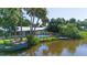 An aerial view of the home with a canal and dock at 418 Acacia Cir, Port Orange, FL 32127
