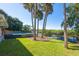 Backyard featuring dock and above ground pool overlooking the water at 418 Acacia Cir, Port Orange, FL 32127