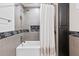 Tiled bathtub with showerhead, storage cabinet, and glass mosaic accents, creating a calming retreat at 418 Acacia Cir, Port Orange, FL 32127
