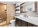 Stylish bathroom with wood-look tiled walls, a modern vanity, and a walk-in shower at 418 Acacia Cir, Port Orange, FL 32127